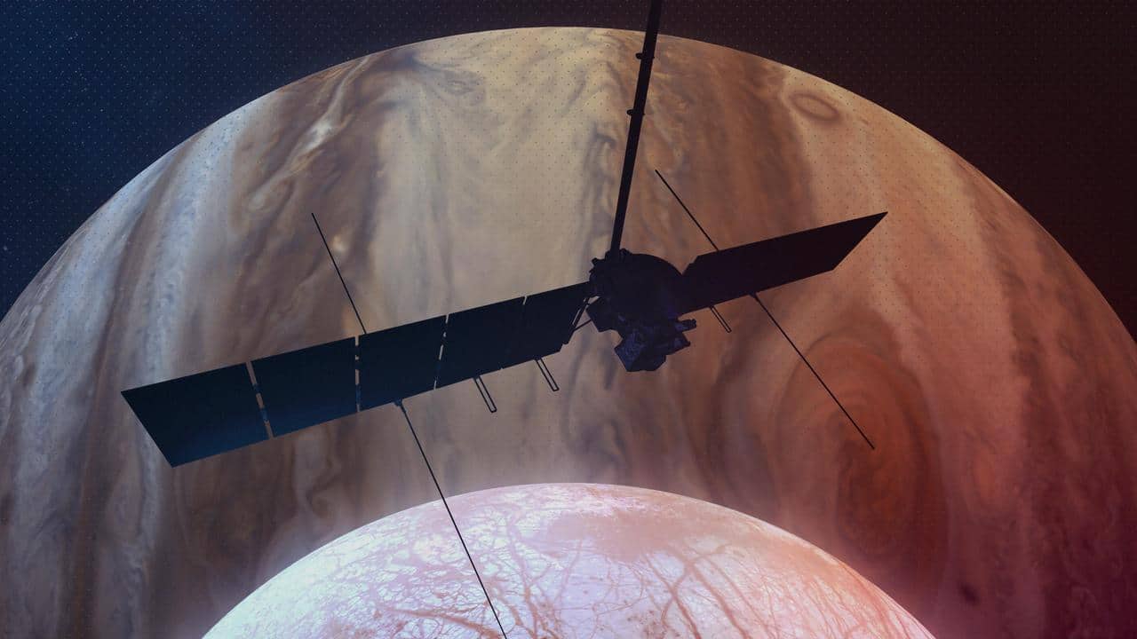 Concept artistico della sonda Europa Clipper con Giove e la luna Europa sullo sfondo